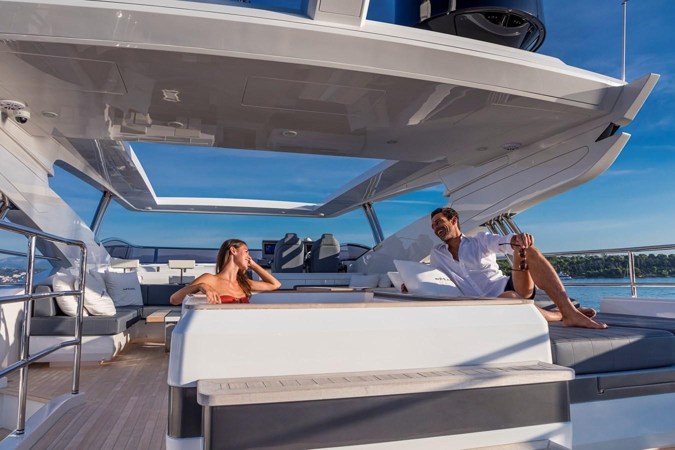 a couple sitting on a yacht aboard AMIRA Yacht for Sale