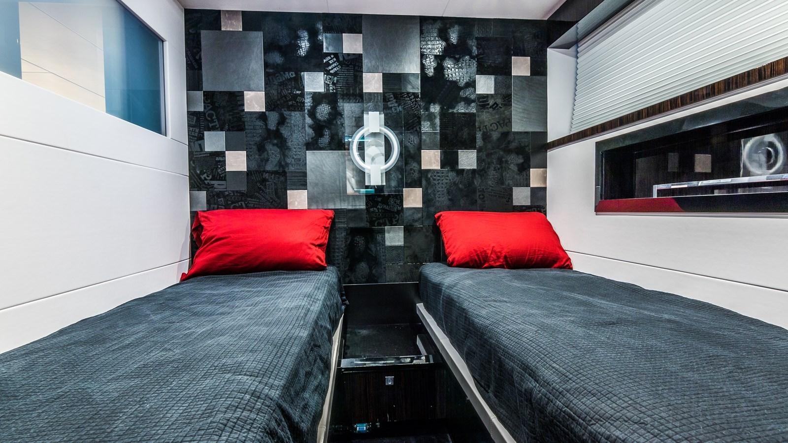a room with a bed and a black and red pillow aboard SEXY Yacht for Sale
