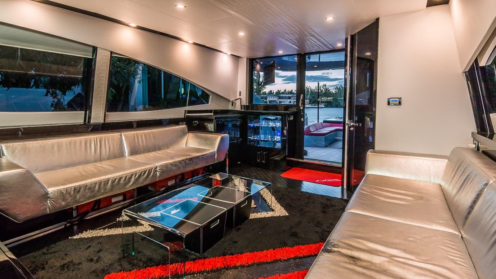 a room with a pool table and couches aboard SEXY Yacht for Sale