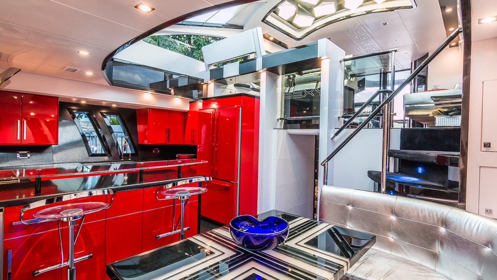 a large room with red cabinets and a blue bowl on the floor aboard SEXY Yacht for Sale