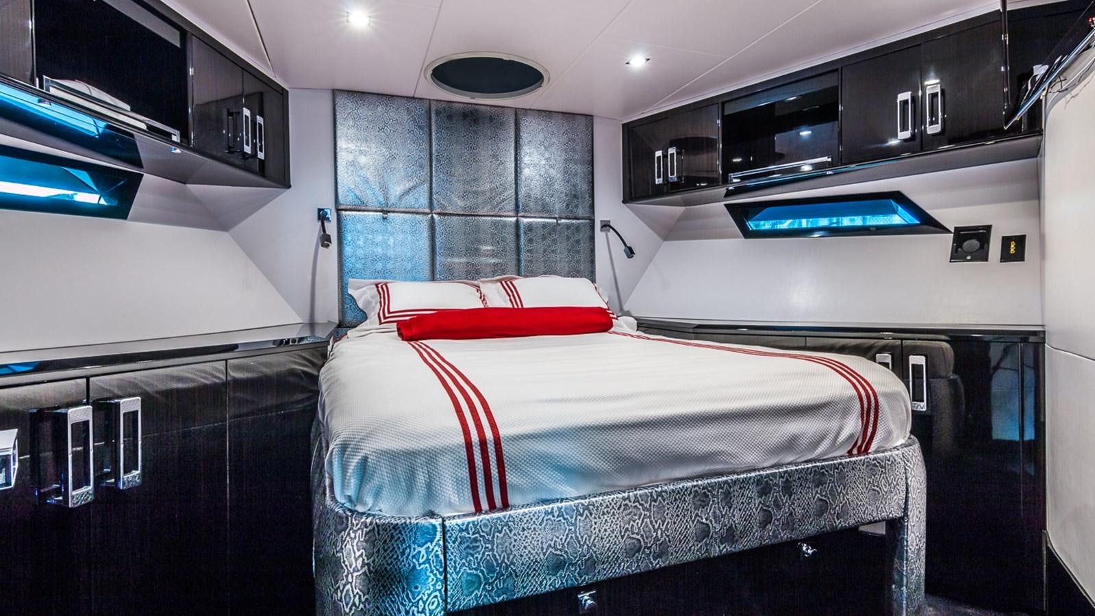 a bedroom with a bed and a tv aboard SEXY Yacht for Sale