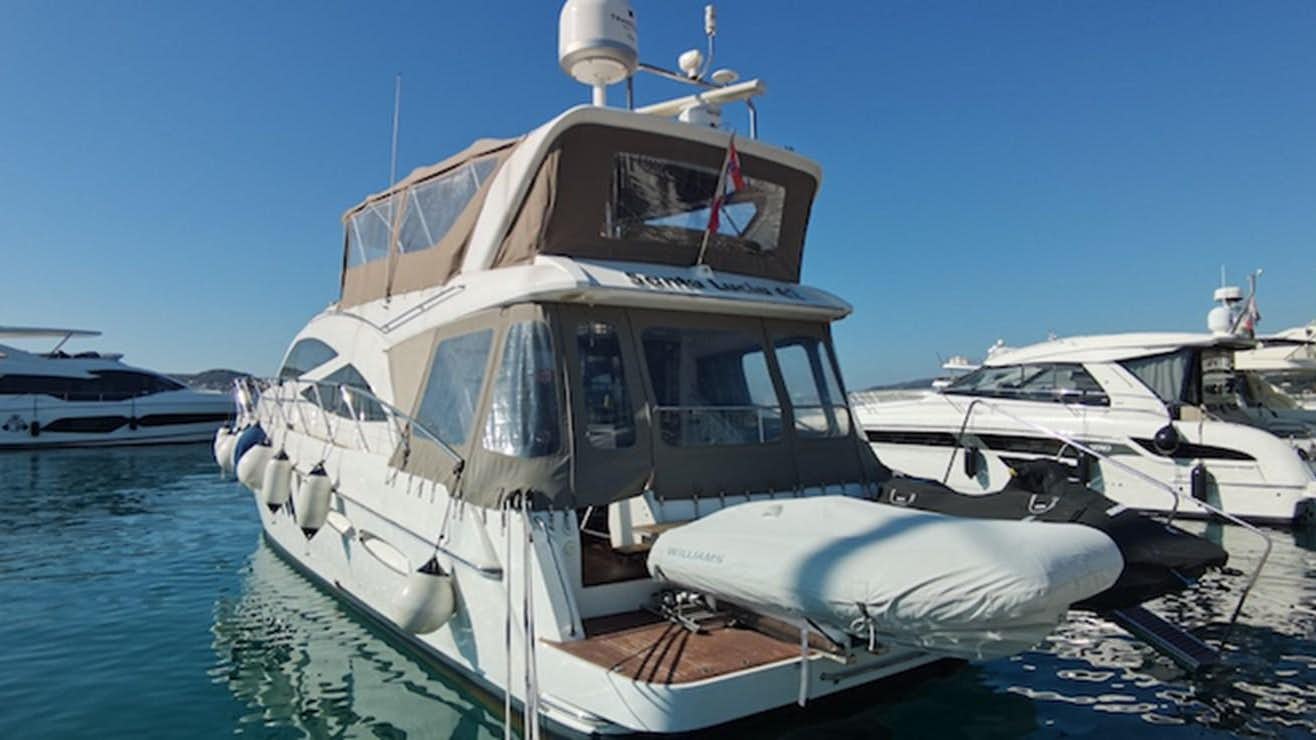 a boat docked at a pier aboard 2010 SEALINE T60 AURA Yacht for Sale