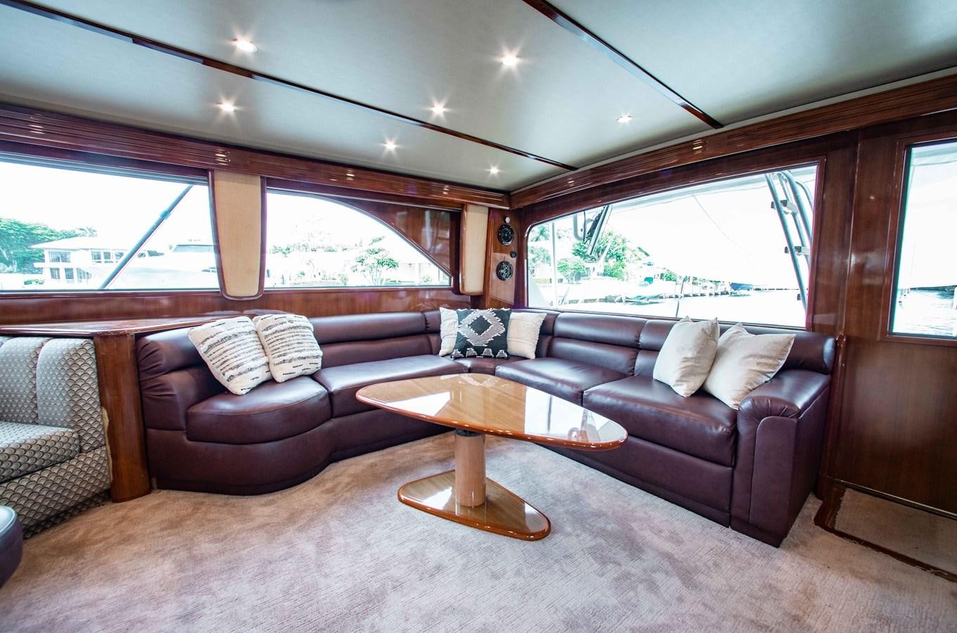 a living room with leather couches aboard CURIOUS GEORGE Yacht for Sale