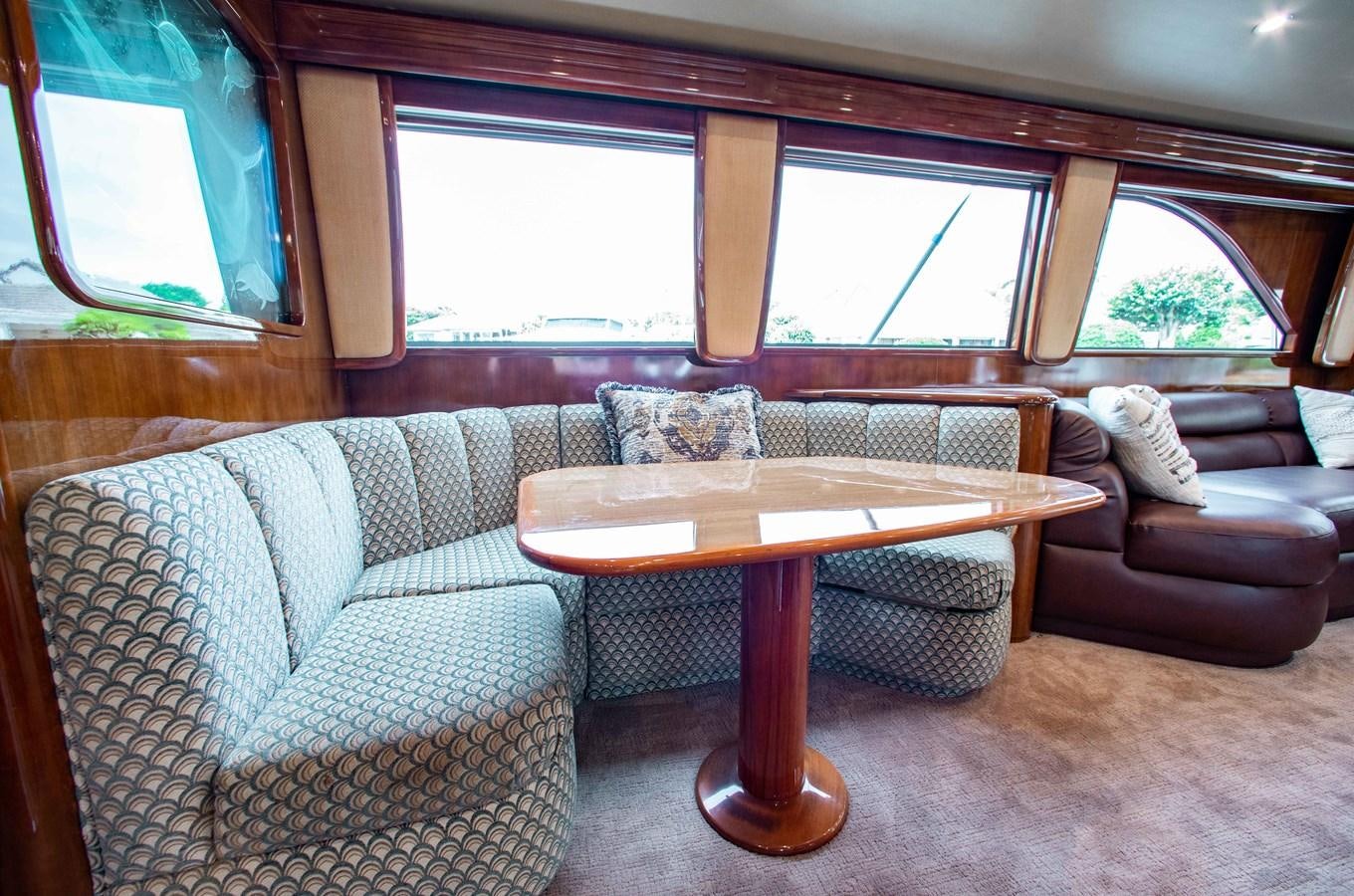 a living room with a couch and a table aboard CURIOUS GEORGE Yacht for Sale