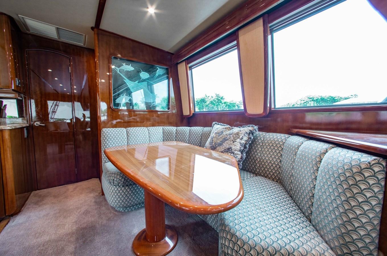 a table and chairs in a room aboard CURIOUS GEORGE Yacht for Sale
