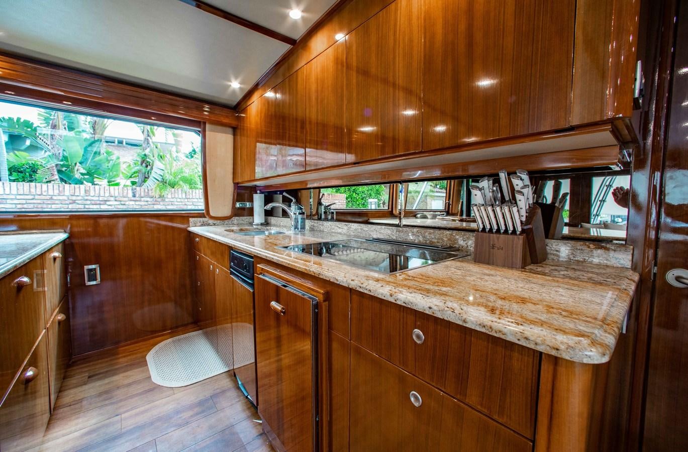 a kitchen with wooden cabinets aboard CURIOUS GEORGE Yacht for Sale