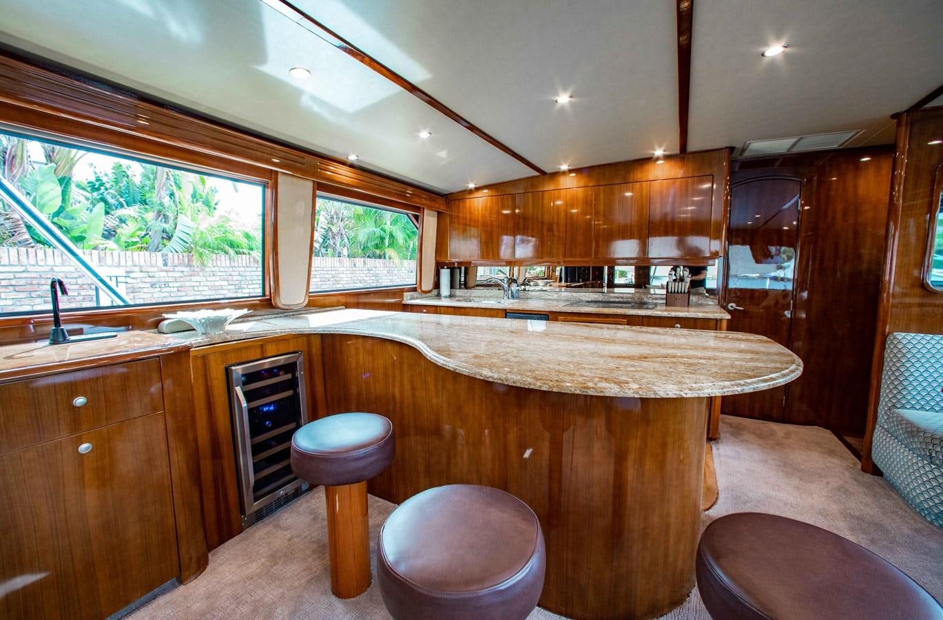 a kitchen with wooden cabinets aboard CURIOUS GEORGE Yacht for Sale