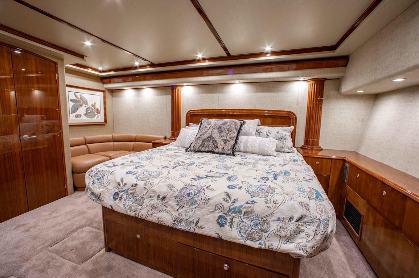 a bed with a white comforter aboard CURIOUS GEORGE Yacht for Sale