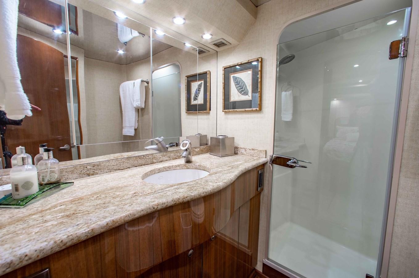 a bathroom with a countertop sink and mirror aboard CURIOUS GEORGE Yacht for Sale