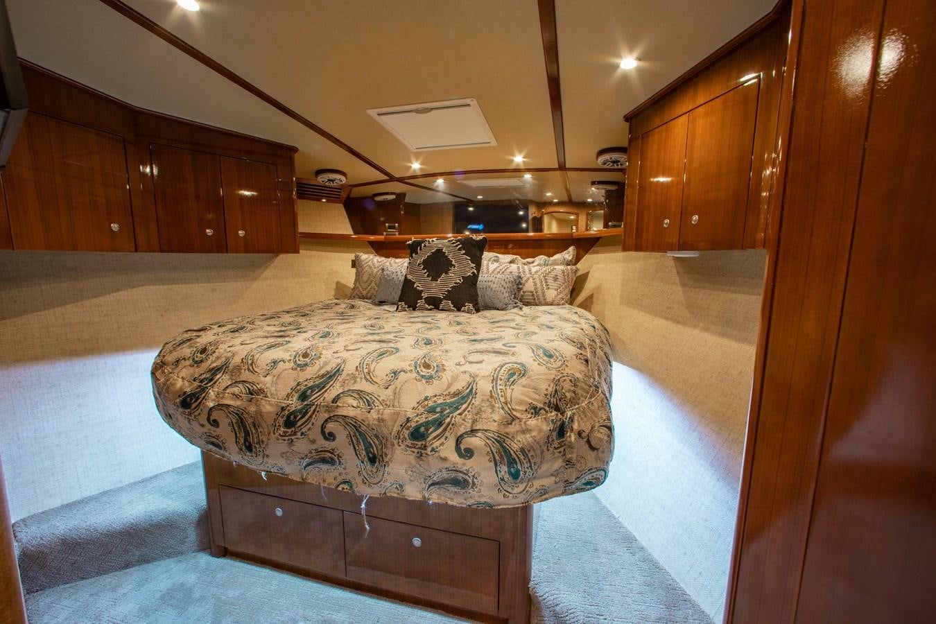 a room with a couch and a wood cabinet aboard CURIOUS GEORGE Yacht for Sale