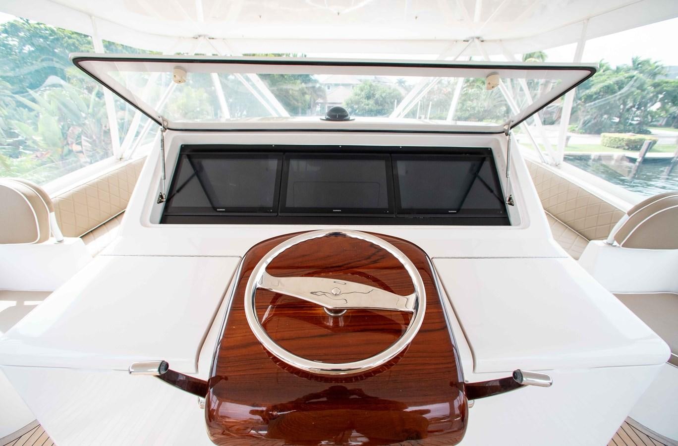 a white car with a steering wheel aboard CURIOUS GEORGE Yacht for Sale