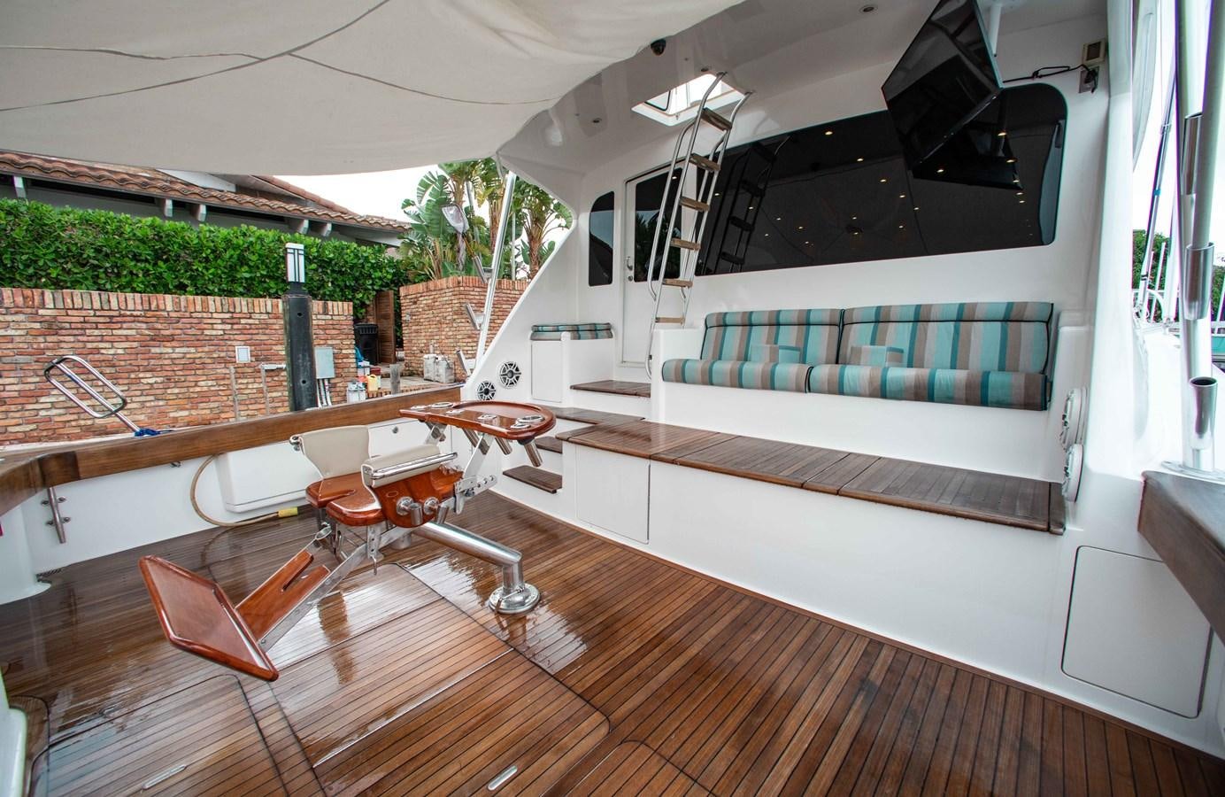 a room with a pool table and chairs aboard CURIOUS GEORGE Yacht for Sale