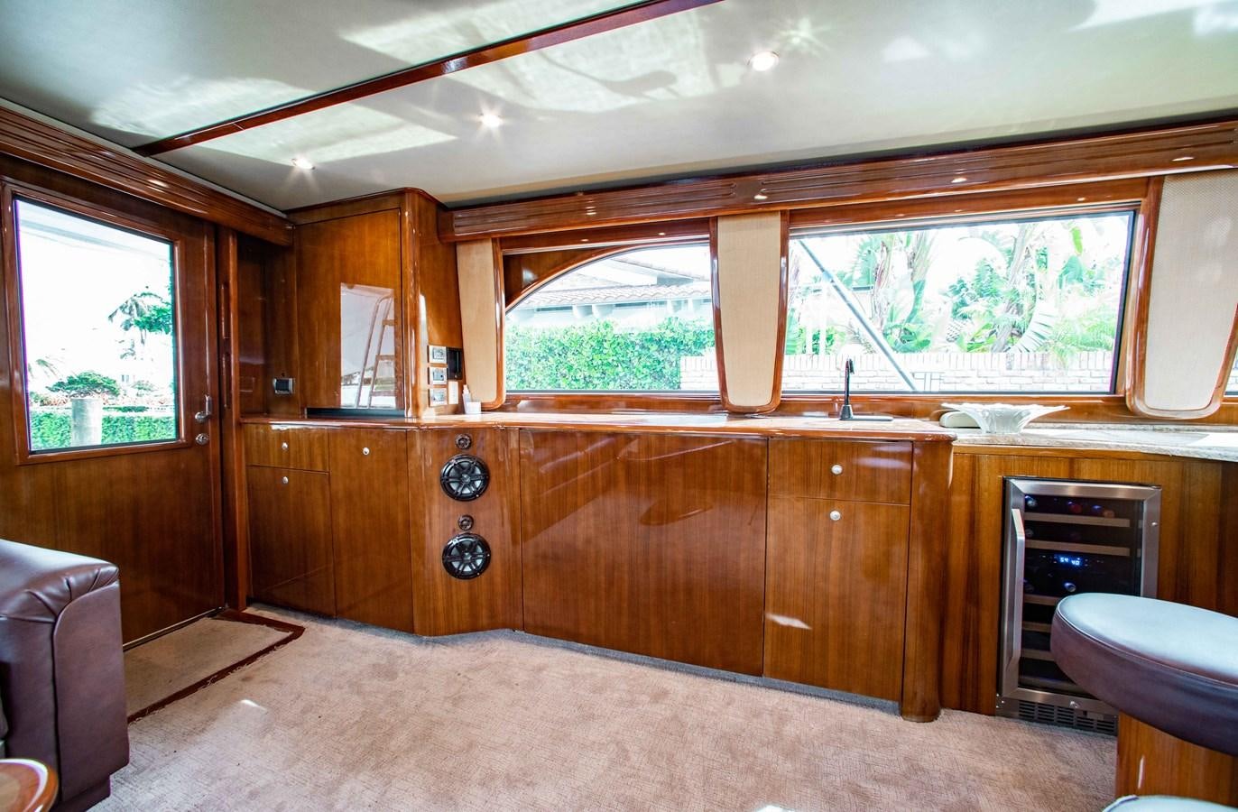 a kitchen with wooden cabinets aboard CURIOUS GEORGE Yacht for Sale