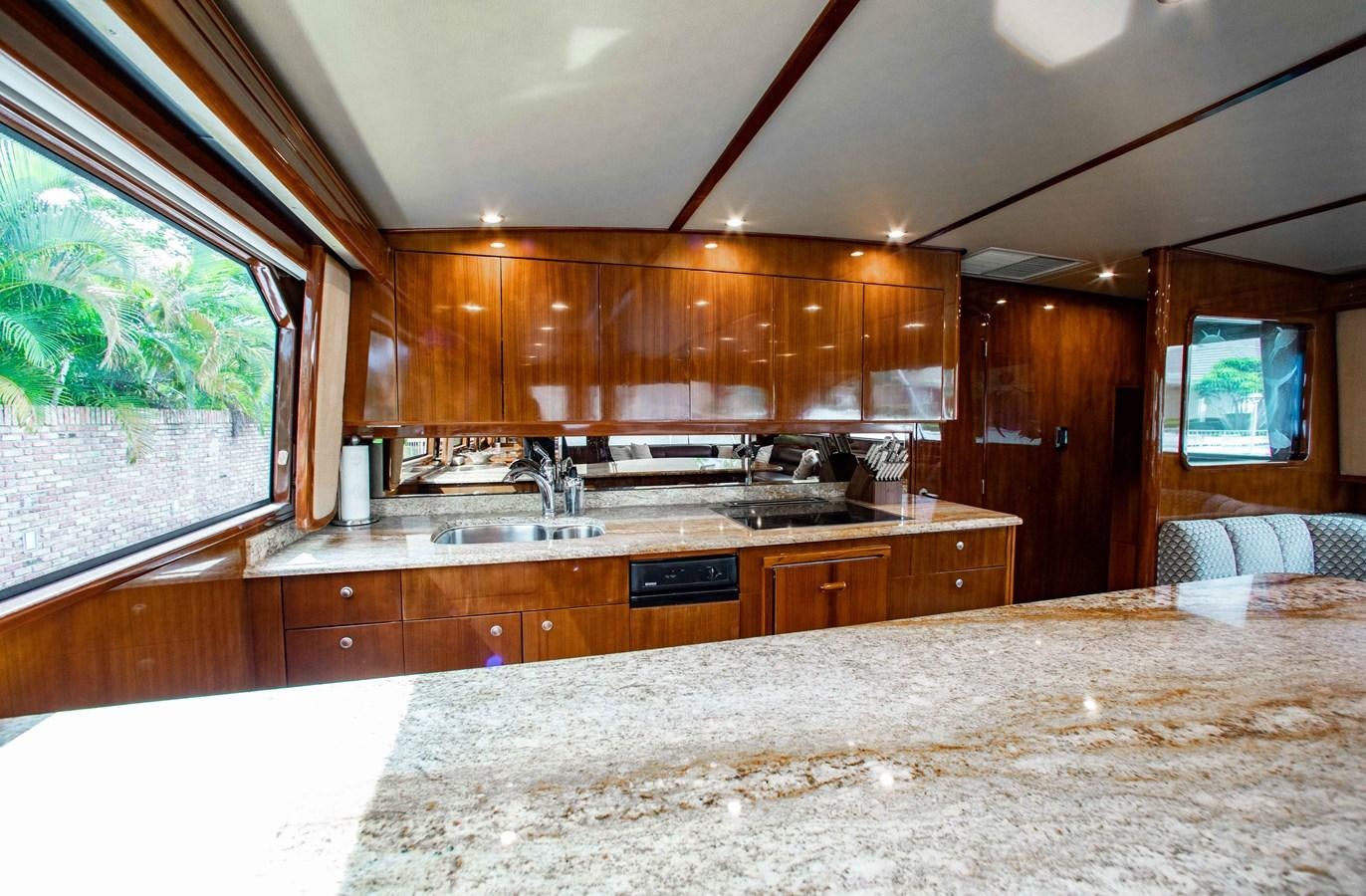 a large kitchen with wooden cabinets aboard CURIOUS GEORGE Yacht for Sale