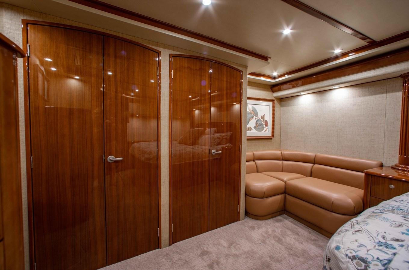 a room with a bed and a door aboard CURIOUS GEORGE Yacht for Sale