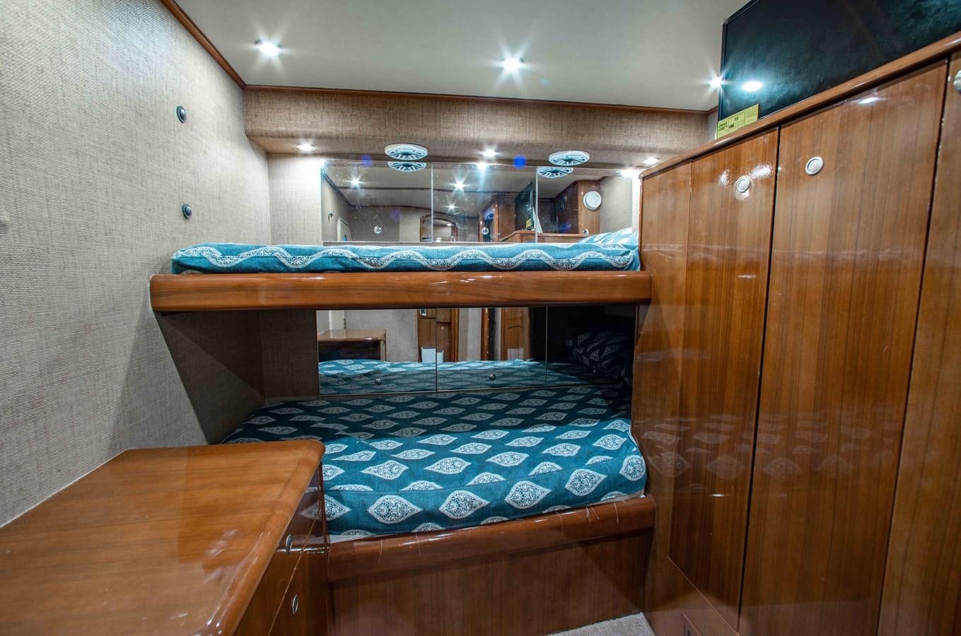 a bed in a room aboard CURIOUS GEORGE Yacht for Sale