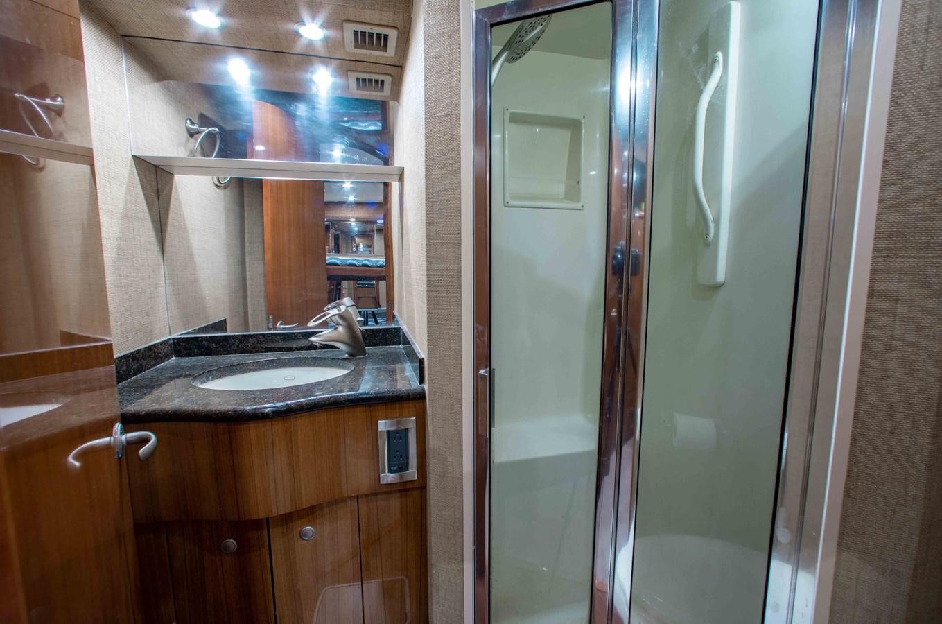 a bathroom with a glass shower aboard CURIOUS GEORGE Yacht for Sale