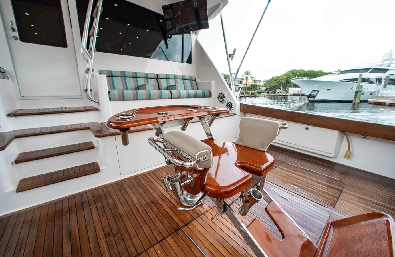 a boat with a deck and chairs aboard CURIOUS GEORGE Yacht for Sale