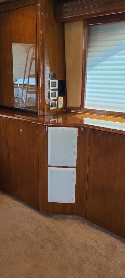 a wood cabinet in a room aboard CURIOUS GEORGE Yacht for Sale