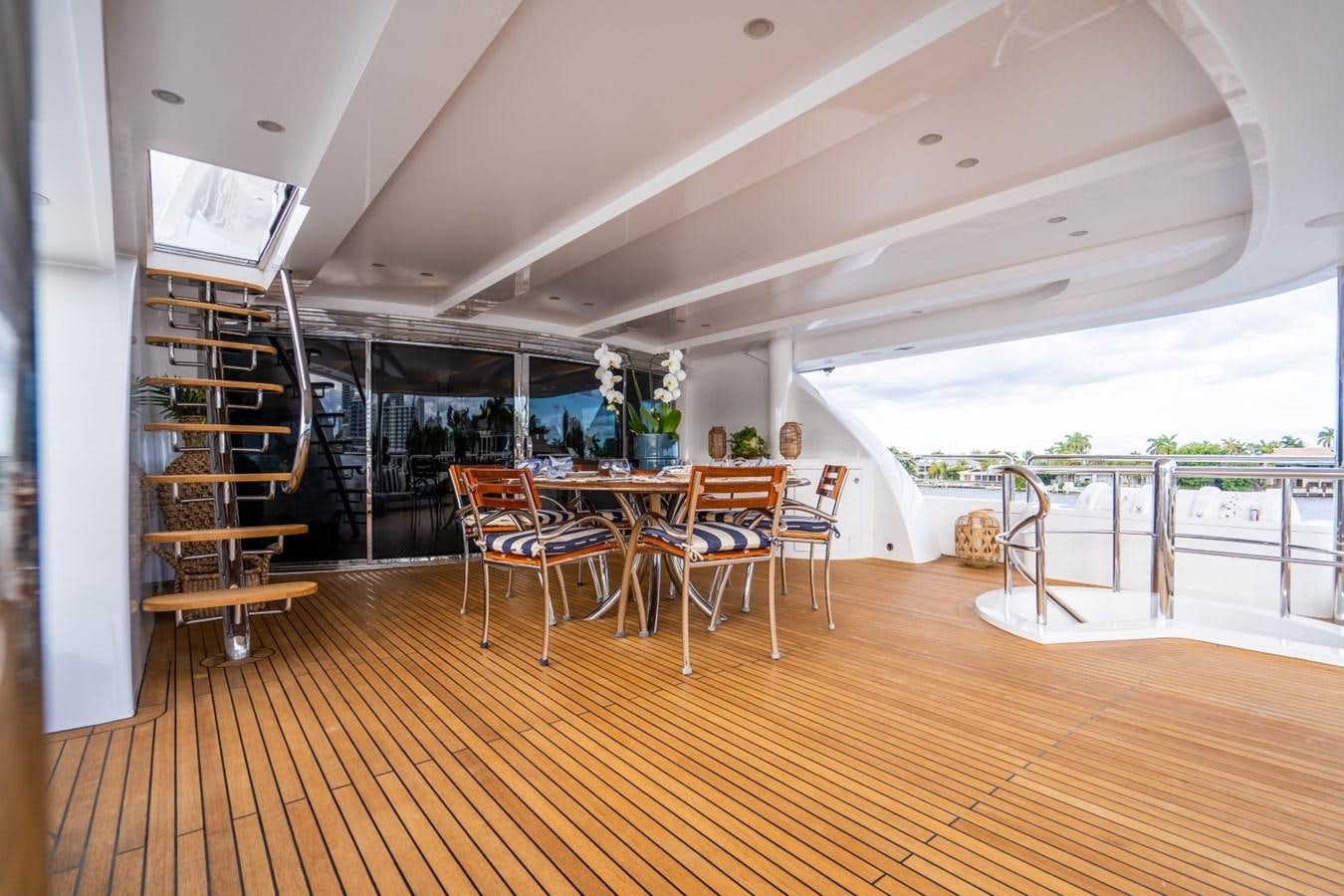 a room with a wood floor and chairs and a wood floor aboard DREAMER Yacht for Sale