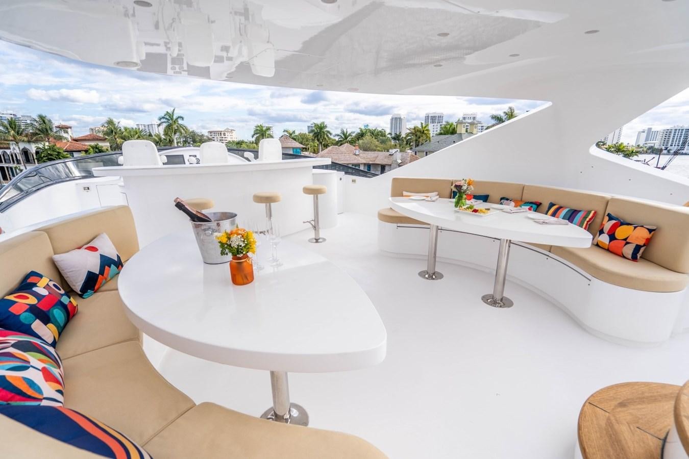 a table and chairs on a balcony aboard DREAMER Yacht for Sale