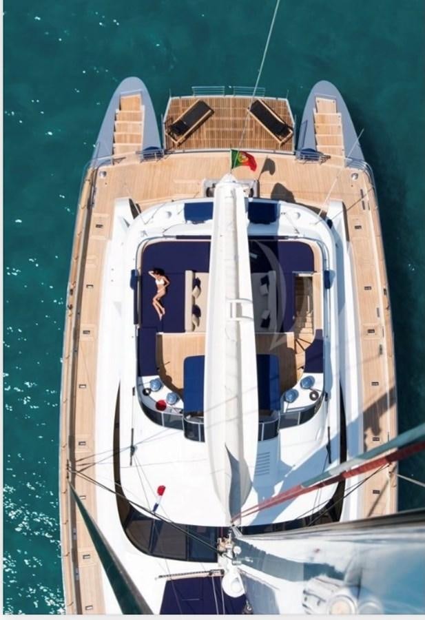 a boat with a large ship on it aboard MANTANI Yacht for Charter