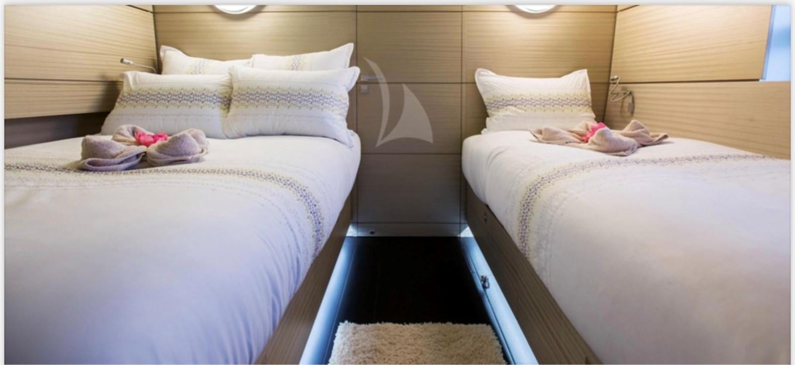 a couple of beds in a room aboard MANTANI Yacht for Sale