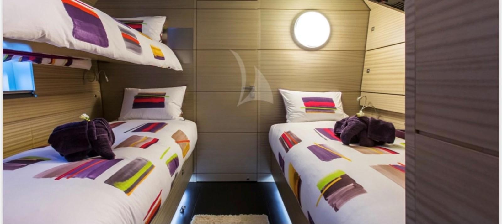 a room with beds and a window aboard MANTANI Yacht for Sale