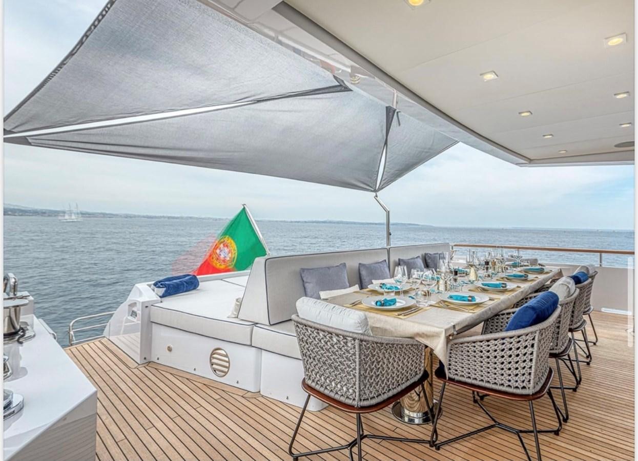 a table and chairs on a deck aboard MILLESIME Yacht for Charter