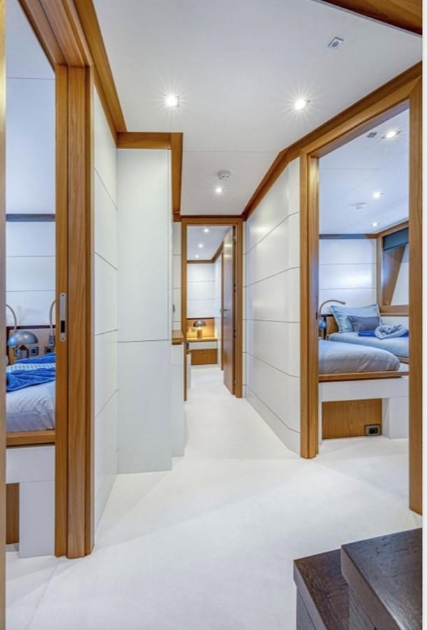 a room with a bed and a mirror aboard MILLESIME Yacht for Charter