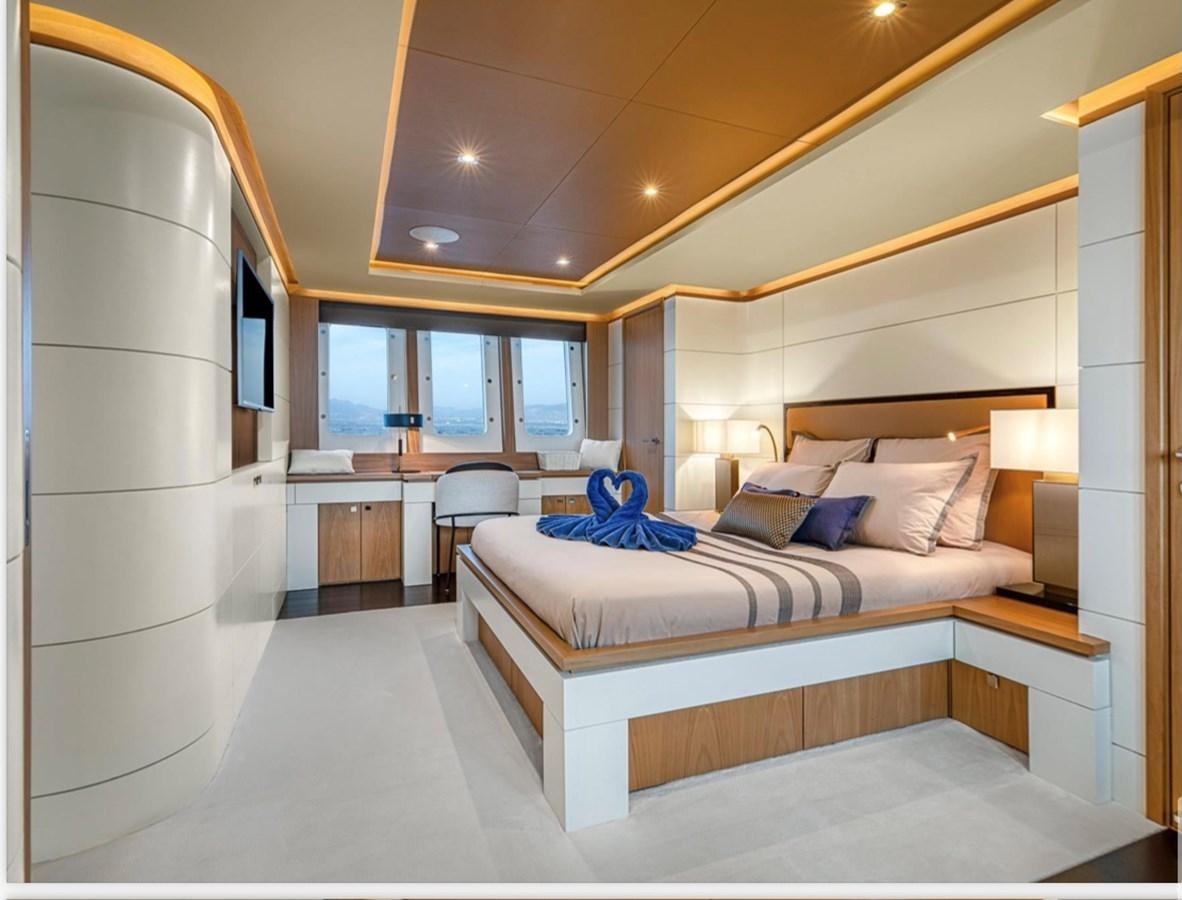 a hotel room with a bed and a desk aboard MILLESIME Yacht for Charter