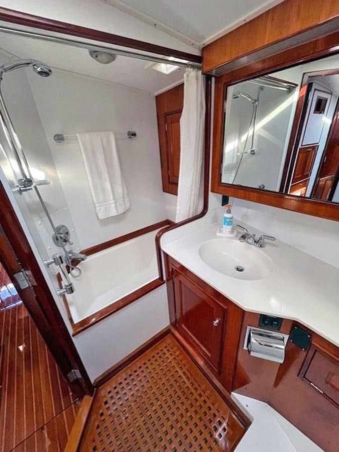 a bathroom with a sink and a mirror aboard SIROCCO Yacht for Sale