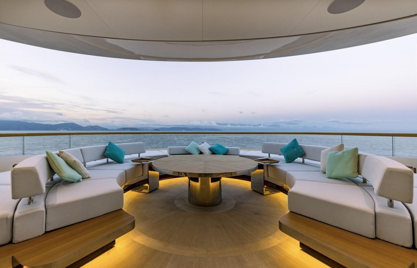 a room with a couch and a table and a large body of water aboard C Yacht for Sale