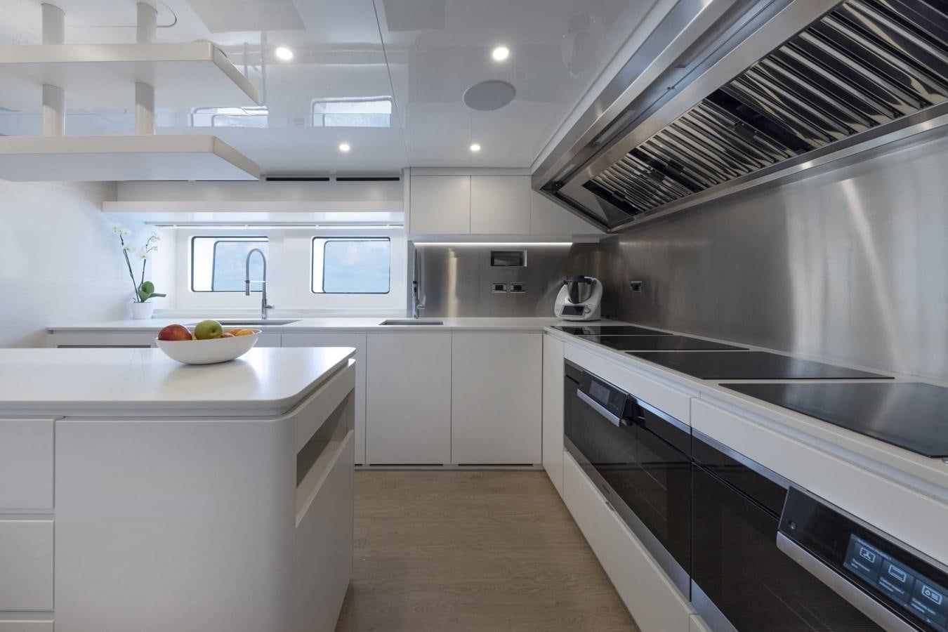 a kitchen with white cabinets aboard C Yacht for Sale