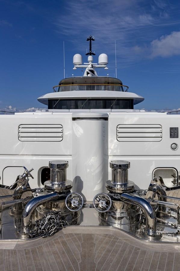 a white boat with a metal engine aboard C Yacht for Sale