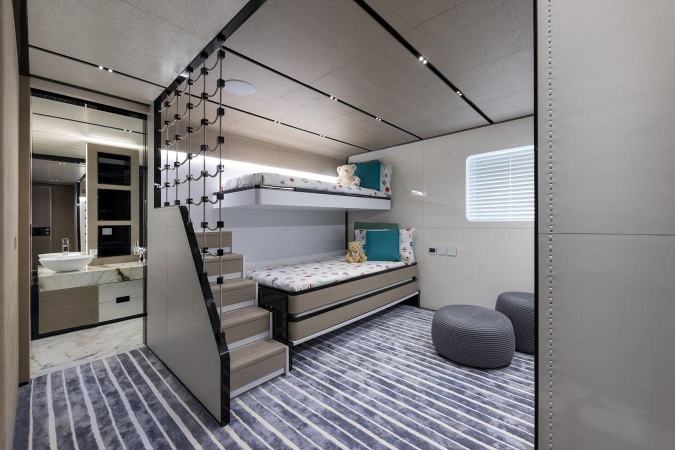 a room with a bed and a desk aboard C Yacht for Sale