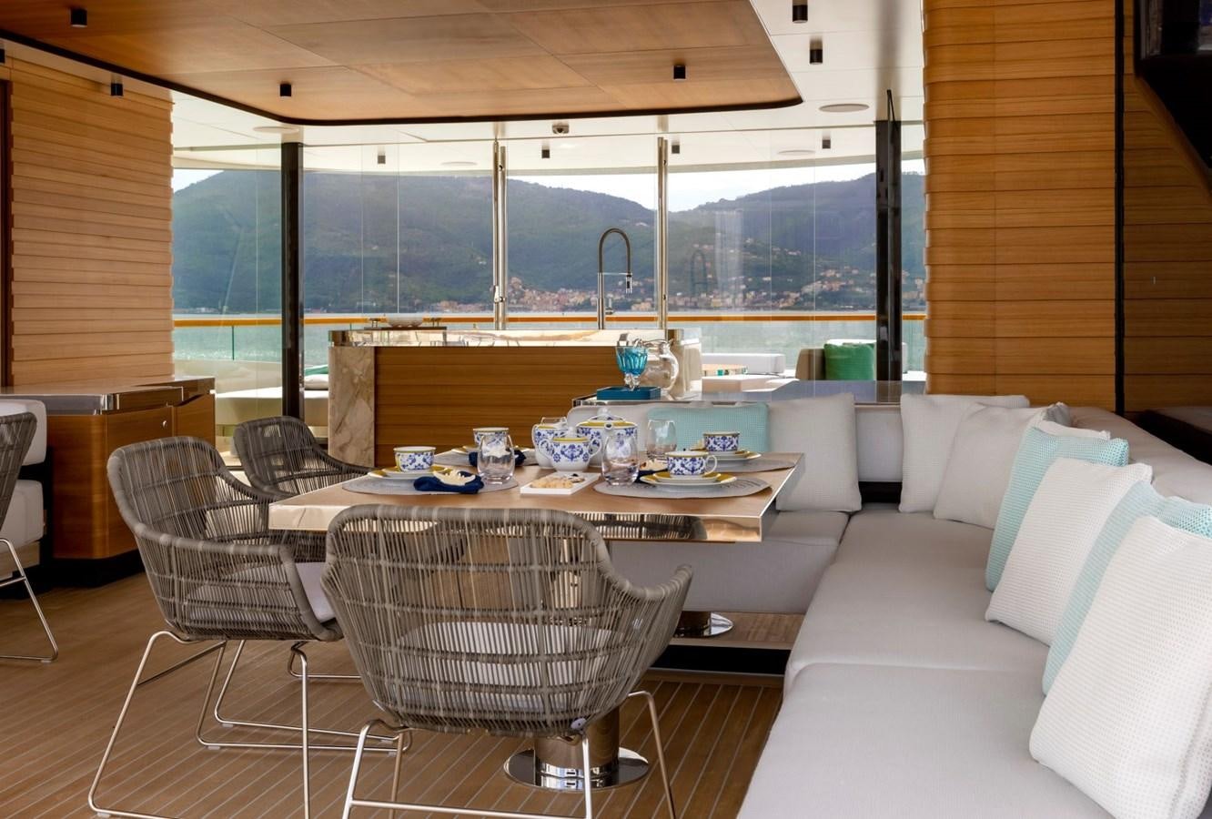 a room with a table and chairs aboard C Yacht for Sale