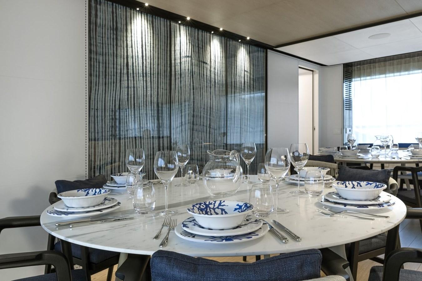 a table with plates and glasses aboard C Yacht for Sale