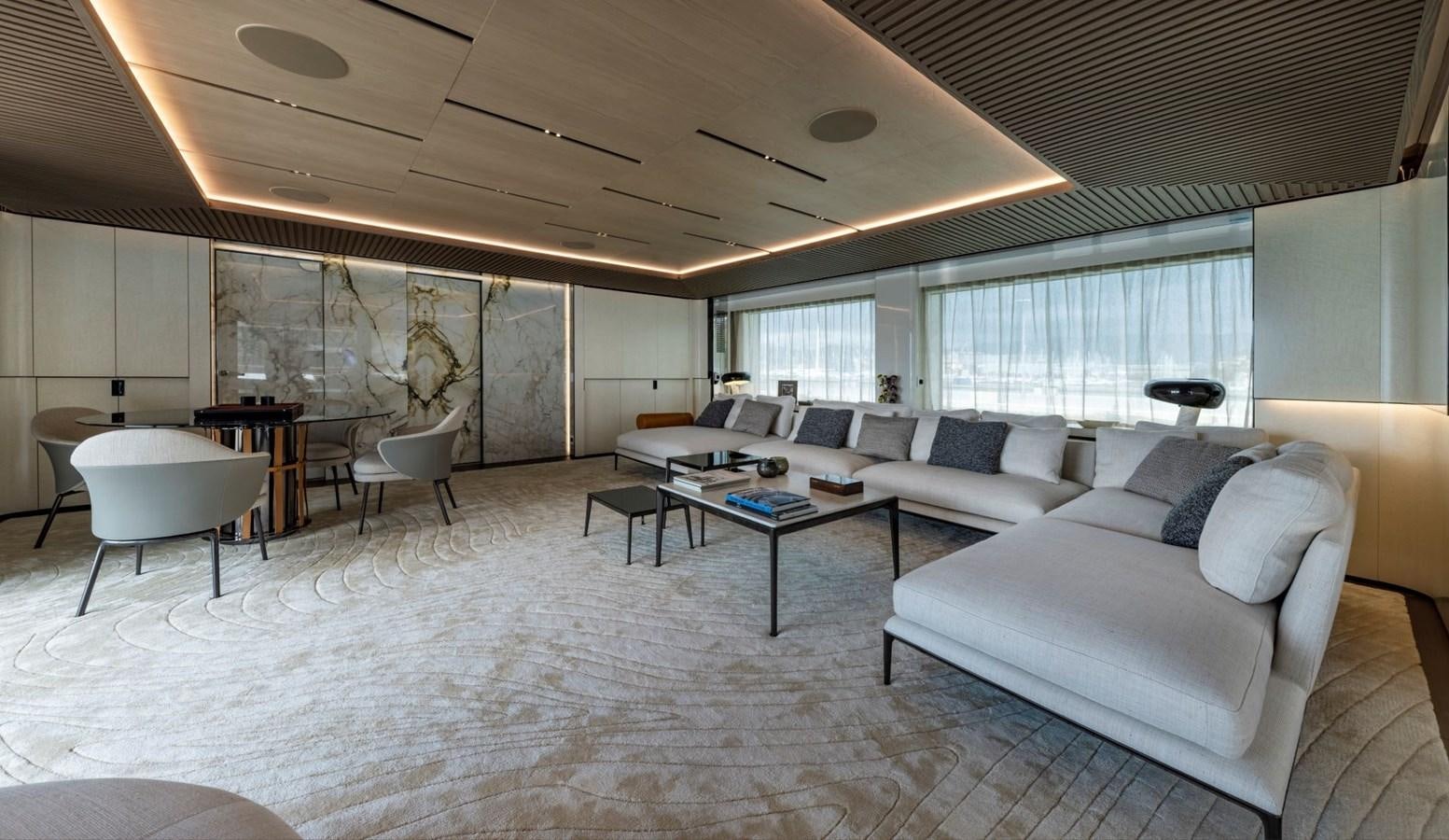 a large living room with white furniture aboard C Yacht for Sale