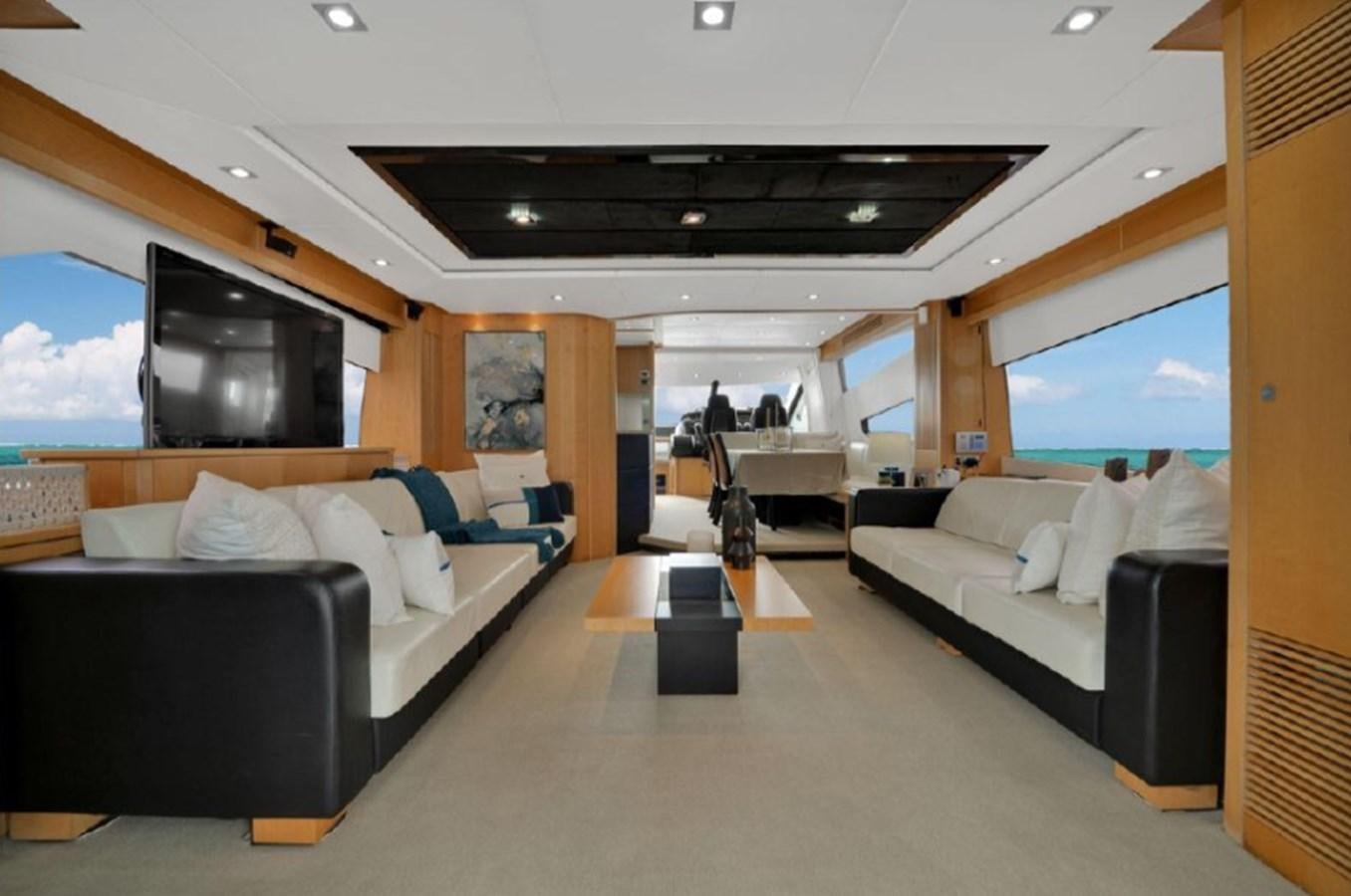 a living room with a large couch and a tv aboard SEADUCTION Yacht for Sale
