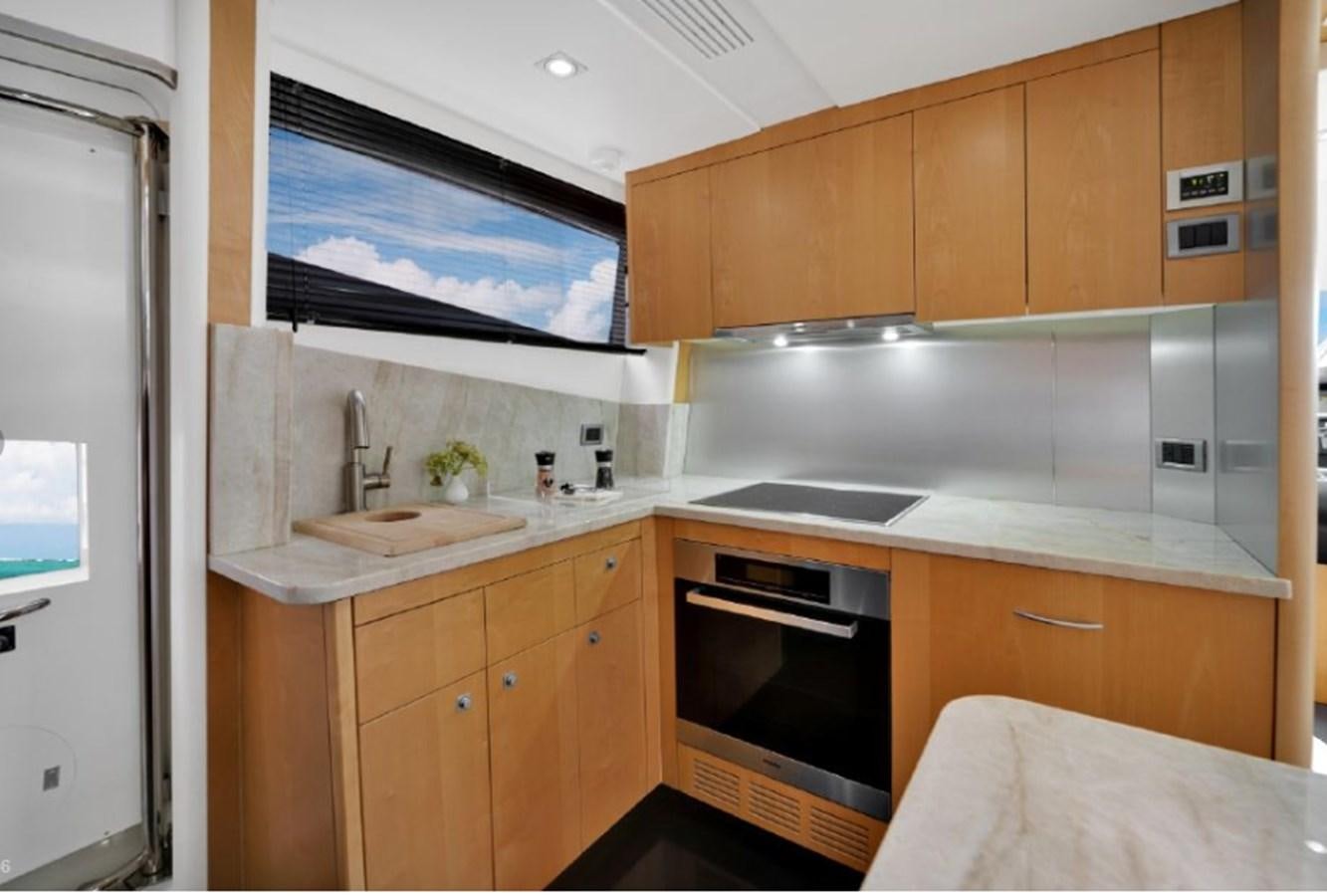 a kitchen with wooden cabinets aboard SEADUCTION Yacht for Sale