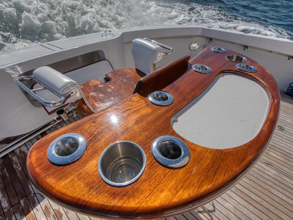 a wooden guitar on a wooden surface aboard EVA VII Yacht for Sale