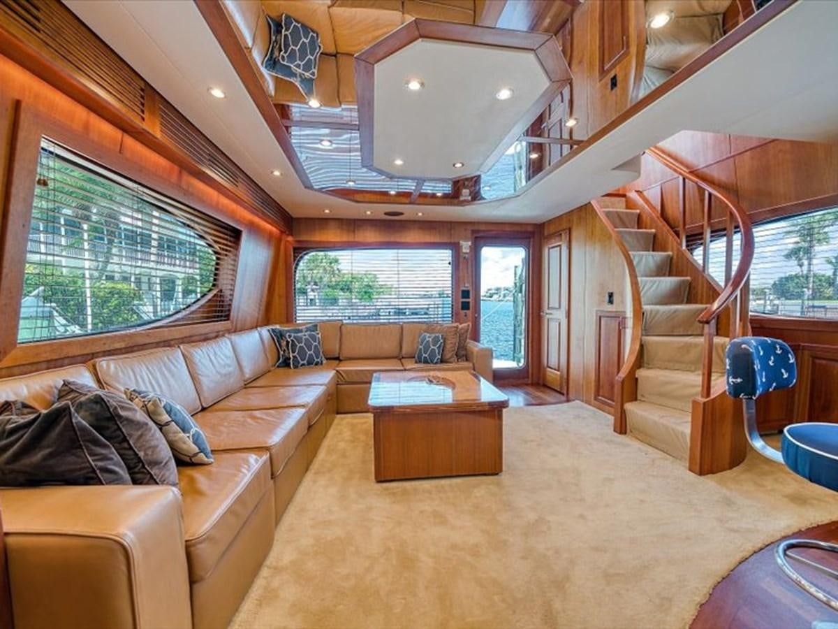 a living room with a large wood staircase aboard EVA VII Yacht for Sale