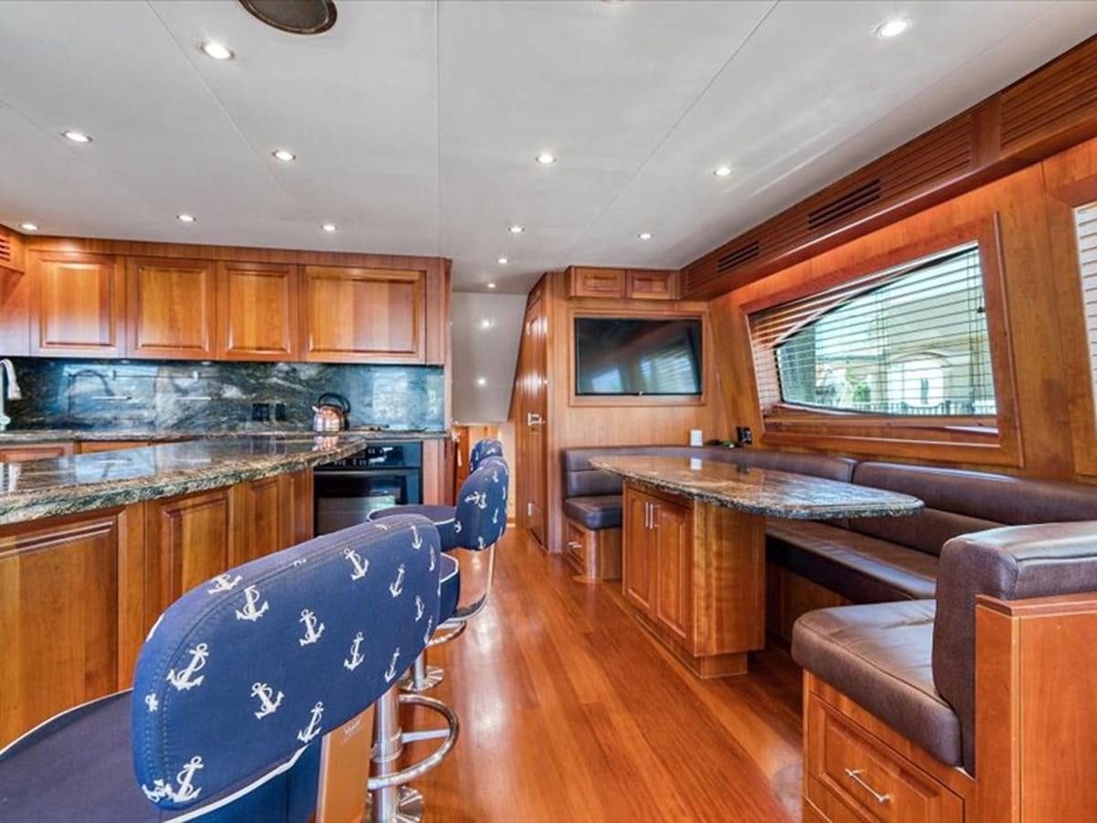 a kitchen with a bar and a couch aboard EVA VII Yacht for Sale