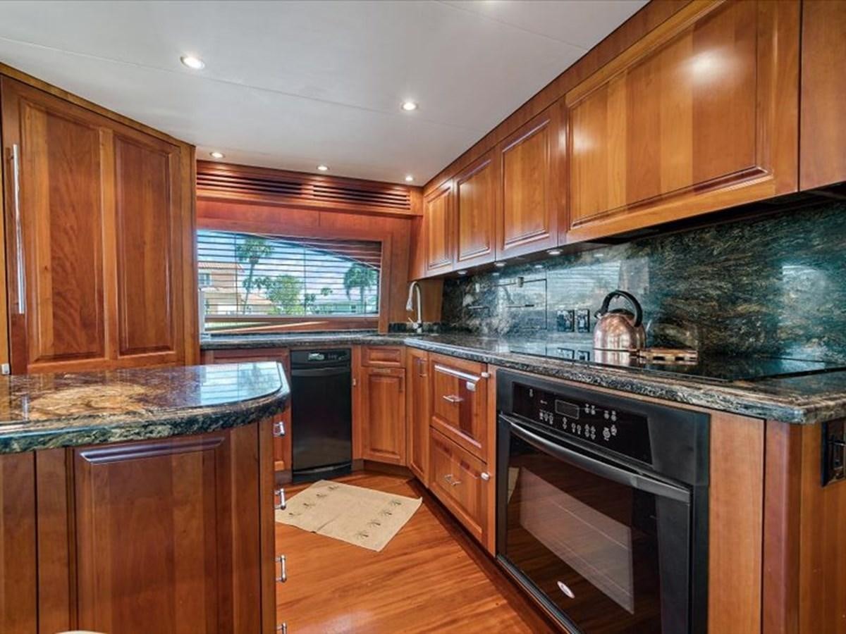 a kitchen with wooden cabinets aboard EVA VII Yacht for Sale