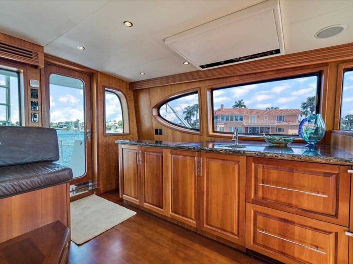 a kitchen with a large window aboard EVA VII Yacht for Sale