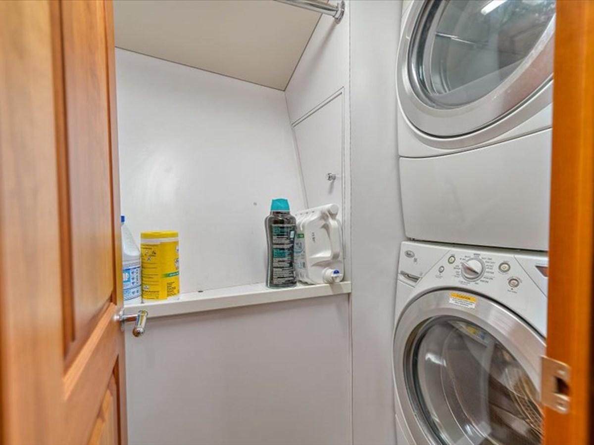 a washer and dryer in a room aboard EVA VII Yacht for Sale