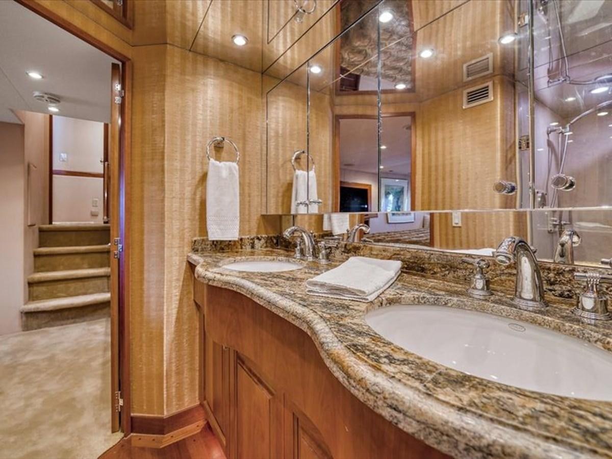 a bathroom with a countertop sink and a mirror aboard EVA VII Yacht for Sale