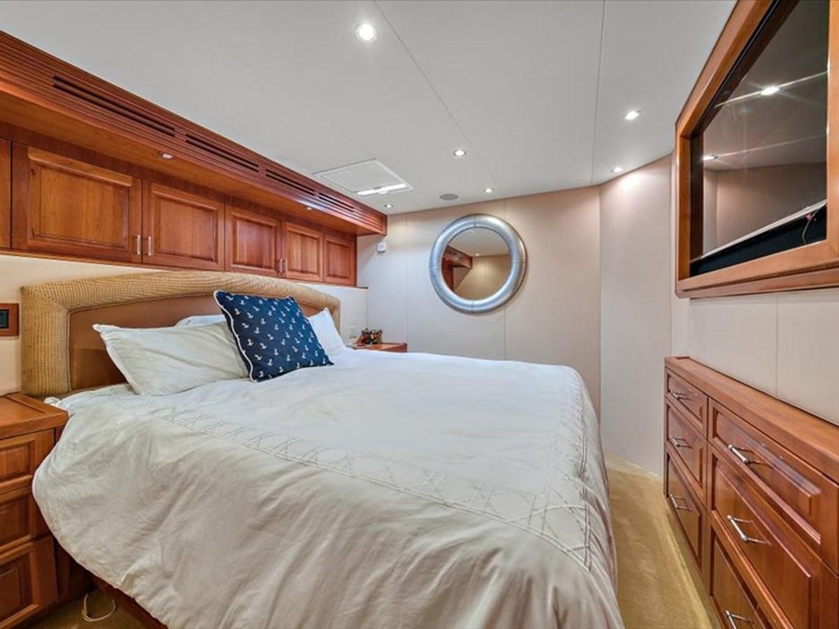 a bedroom with a bed and a mirror aboard EVA VII Yacht for Sale