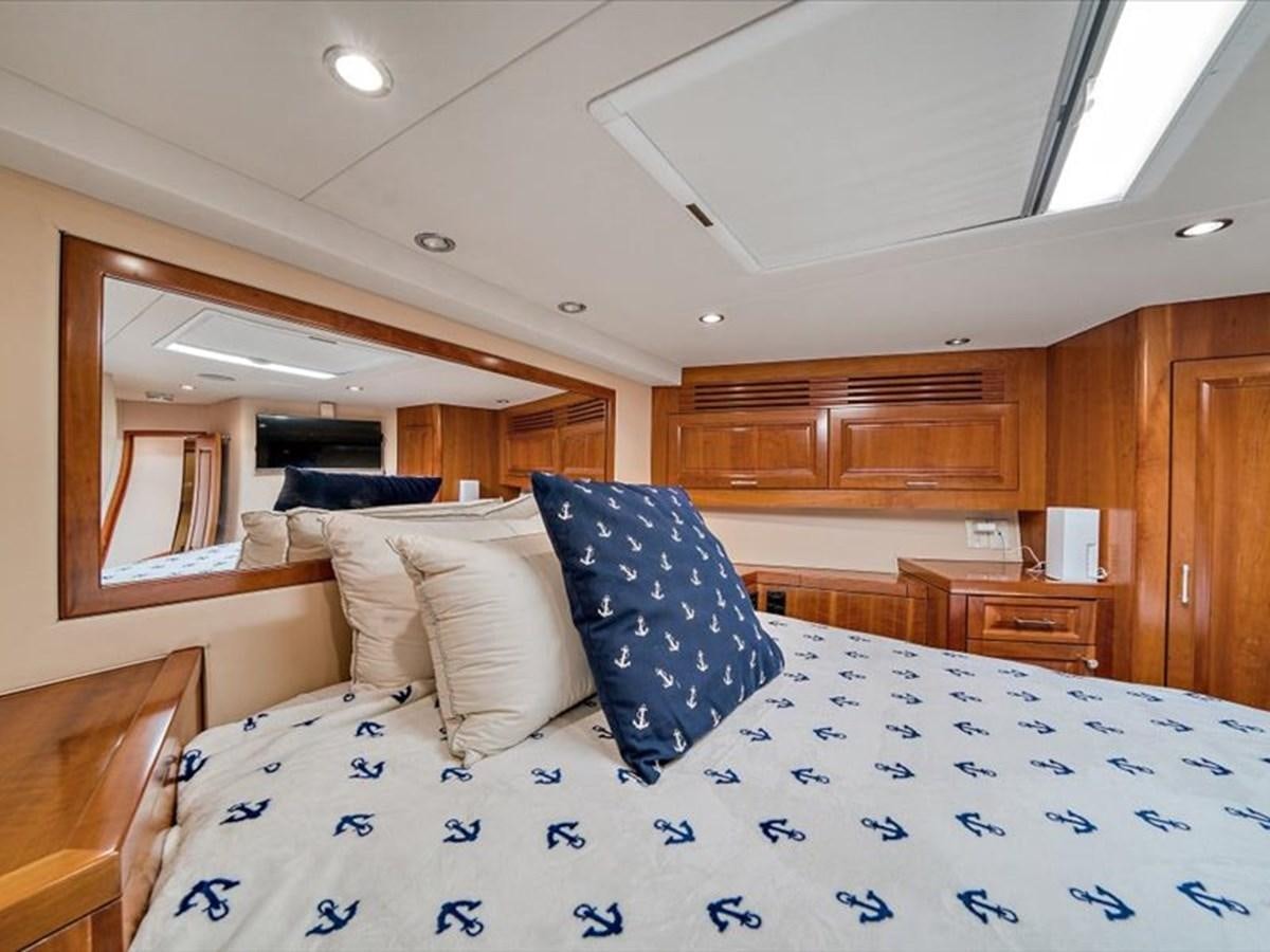 a bedroom with wood cabinets aboard EVA VII Yacht for Sale